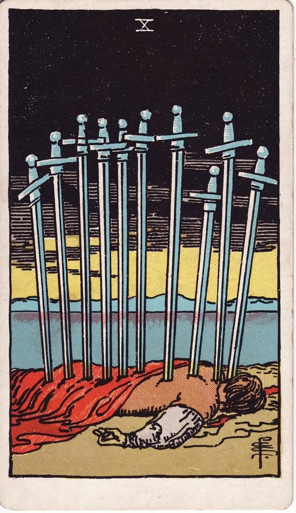 Ten of Swords tarot card: A figure lies face-down at the water's edge, ten swords standing in his back — deliberate overkill, grief's own exaggeration made visible.
