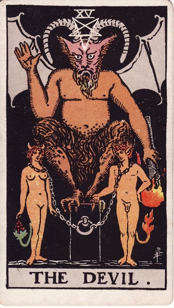 The Devil tarot card — A horned figure squats on a black pedestal, one hand raised in a dark mirror of The Hierophant's ble