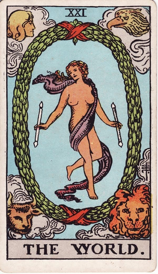 The World tarot card — A dancing figure floats within a great laurel wreath bound by red ribbons, a wand in each hand — mas
